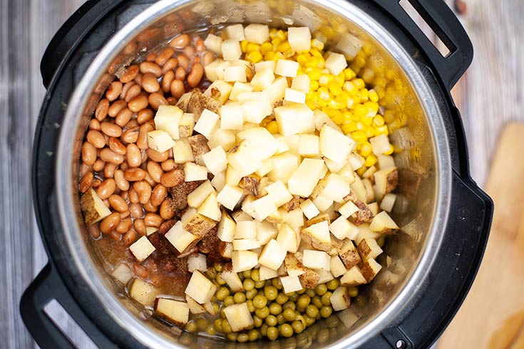 Beans, corn, peas and potatoes sitting in an Instant Pot.