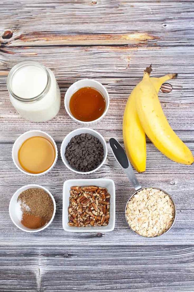 All the Banana Bread Oatmeal Recipe ingredients collected on a wooden table.