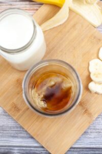 Vanilla extract in an open canning jar.