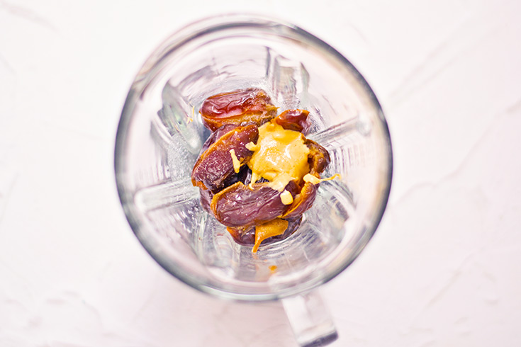 Date Caramel Recipe ingredients sitting in a blender, waiting to be blended.