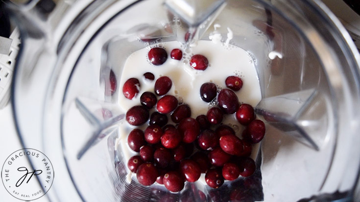 The Fresh Cranberry Smoothie ingredients sitting unblended in a blender.