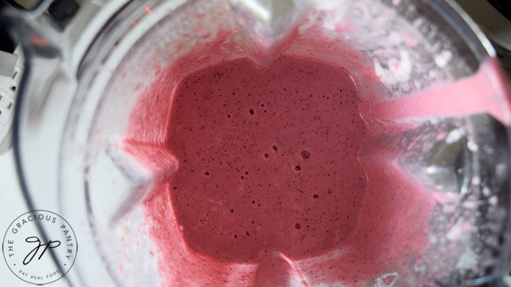 The blended smoothie in a blender.