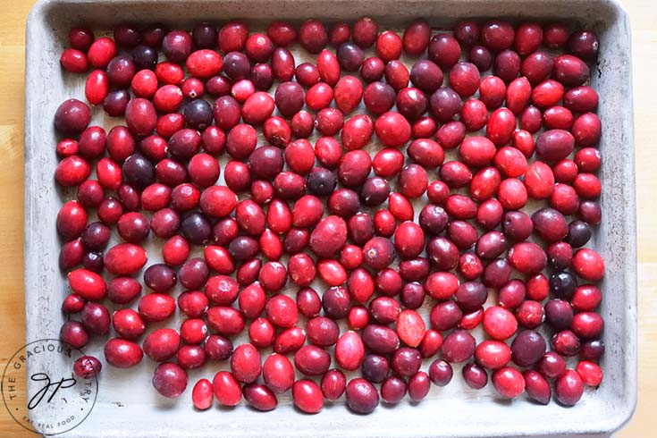 Fresh cranberries frozen on a cookie sheet.