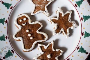 Chilling the just decorated healthy gingerbread cookies on a plate.