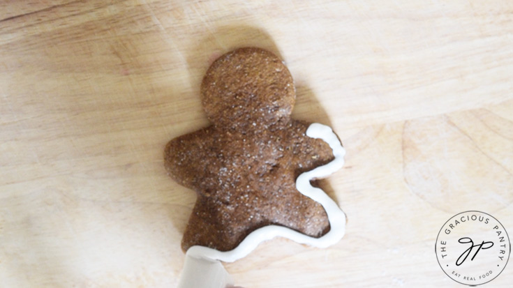 Outlining a gingerbread man with icing.