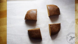 Gingerbread dough ball cut into quarters.