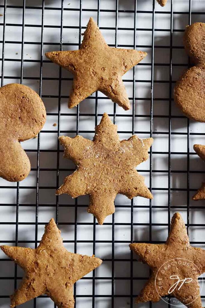Just baked healthy gingerbread cookies in the form or stars, cooling on a black wire cooling rack.