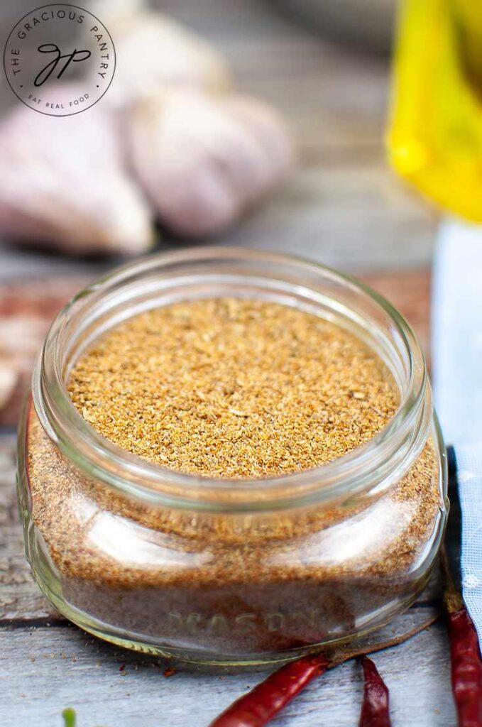 A side view of a jar filled with Homemade Fajita Seasoning.
