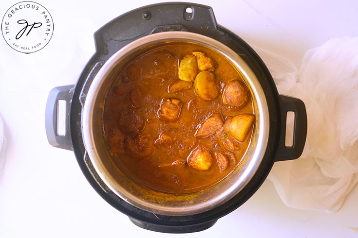 The cooked Jamaican Curry Chicken sitting in an Instant Pot.