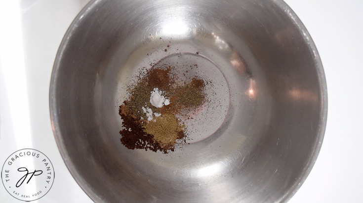 Pfeffernusse Cookie spices in a large stainless steel mixing bowl.