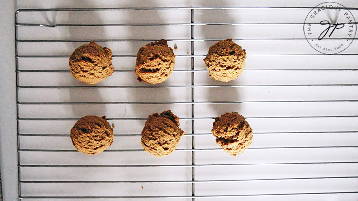 Just baked Pfeffernusse Cookies cooling on a wire rack.