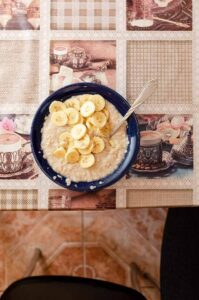 A blue bowl filled with stovetop banana bread oatmeal.