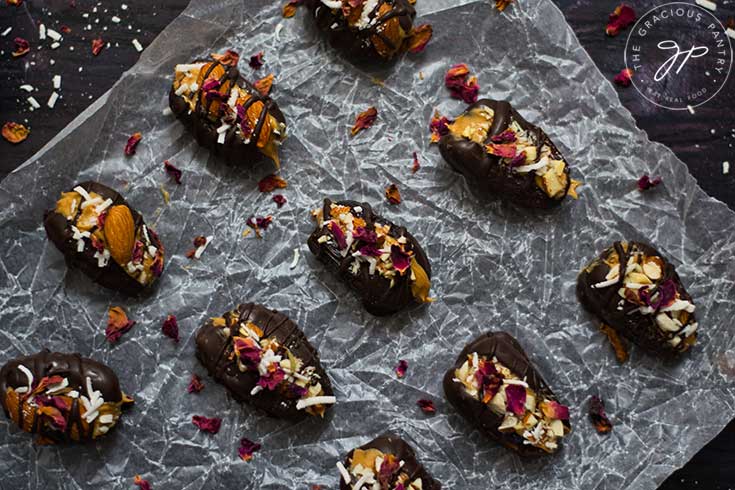 The finished, stuffed dates on a piece of crinkled parchment paper.