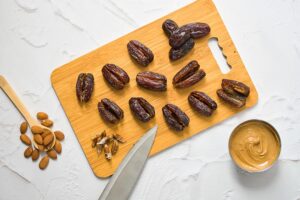 Pitted dates lay on a cutting board.