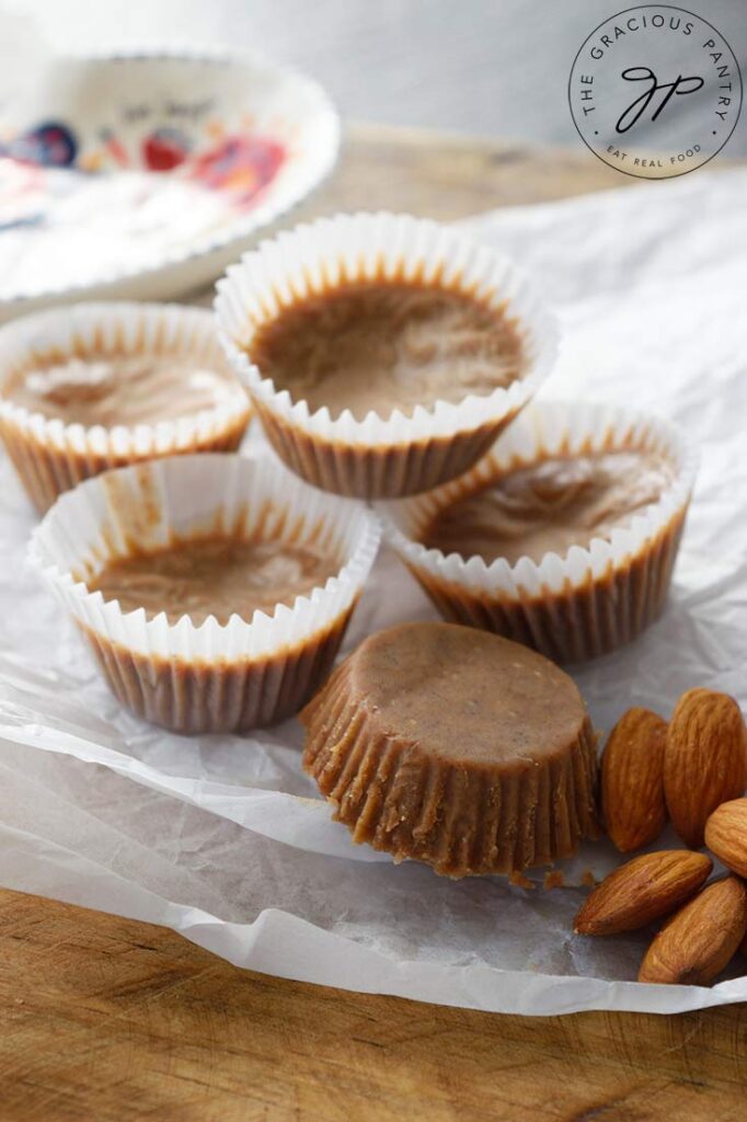 5 Almond Butter Fat Bombs rest on a piece of wrinkled parchment paper.