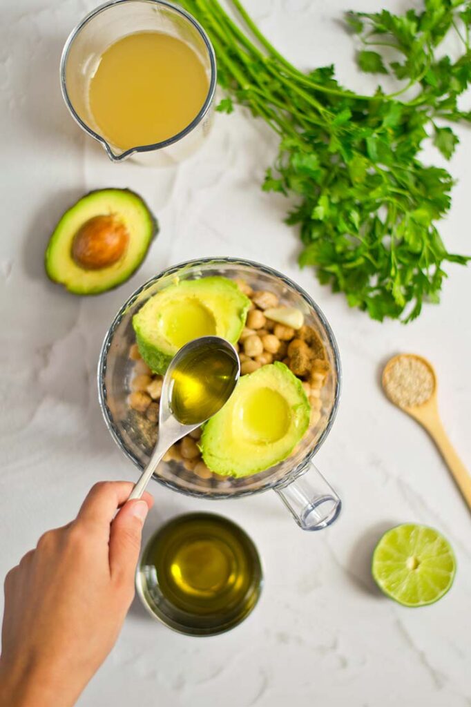 Adding oil to a food processor.