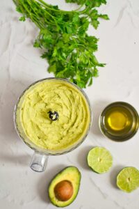 The blended hummus sitting in a food processor bowl.