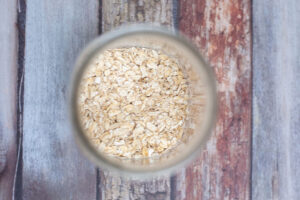 Dry oats added to a canning jar.