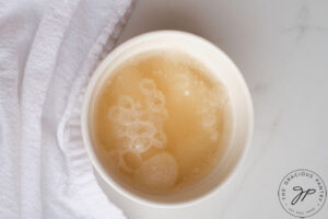 Water and gelatin mixed together in a white bowl.