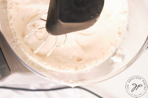 The mixed marshmallow fluff in the electric mixer bowl.