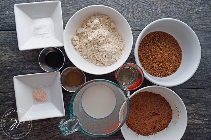 Instant Pot Chocolate Cake Recipe ingredients sitting together in individual bowls on a gray surface.