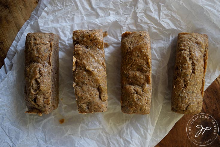 The finished Low Carb Snack Bars lined up on a piece of parchment paper.