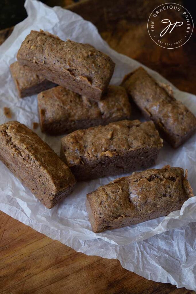 A pile of low carb snack bars pilled up on a piece of parchment paper.