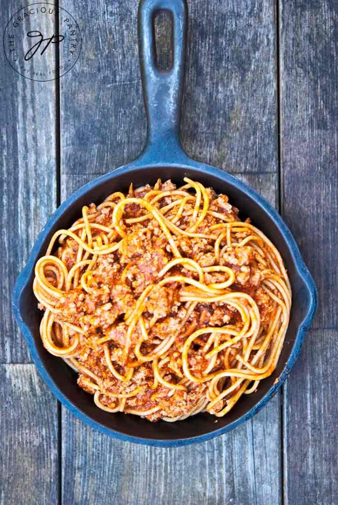 An overhead view looking down into a cast iron skillet filled with this Skillet Spaghetti Recipe.