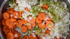 Chopped carrots, celery and onions sitting in a skillet.