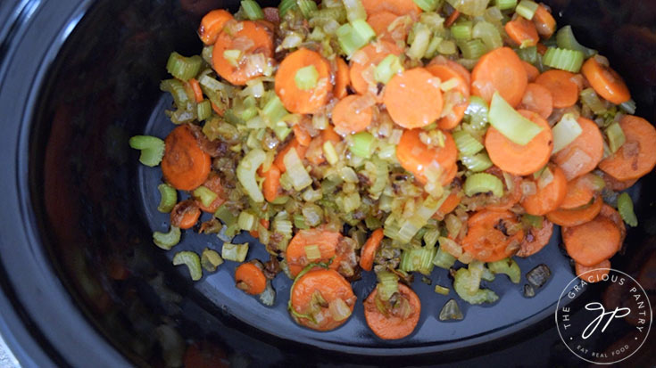 Sautéd celery, carrots and onions in a slow cooker crock.