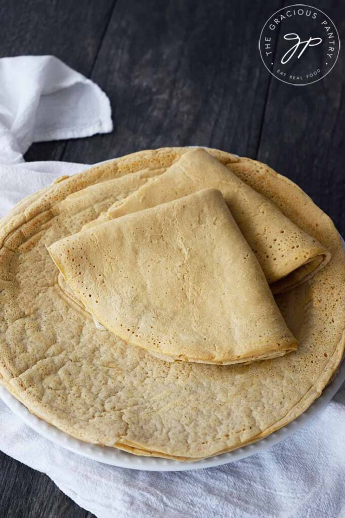 A side view of a plate holding Oat Flour Crepes. The top two crepes are folded.