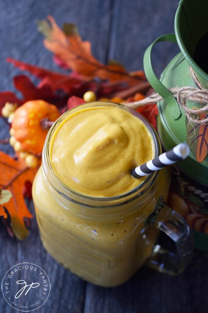 An overhead view looking down into a glass mug filled with this Pumpkin Pie Smoothie Recipe.