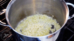 Onions and garlic sautéing in a large stock pot.