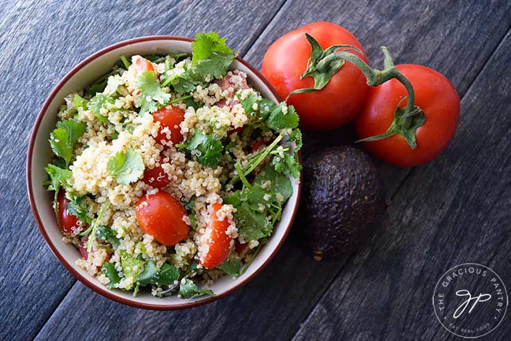 The finished Avocado Quinoa Salad, served in a blue bowl.