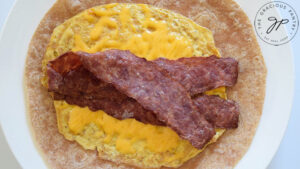 Bacon strips added to the egg pancake and tortilla.