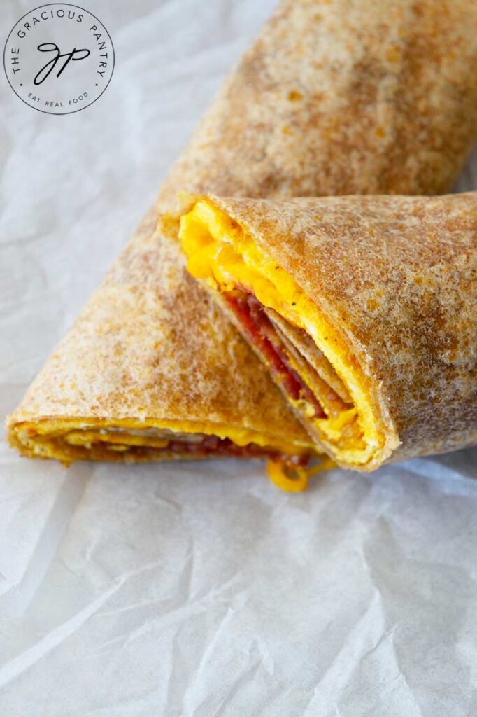 An overhead view looking down onto a cut Bacon And Egg Wrap.