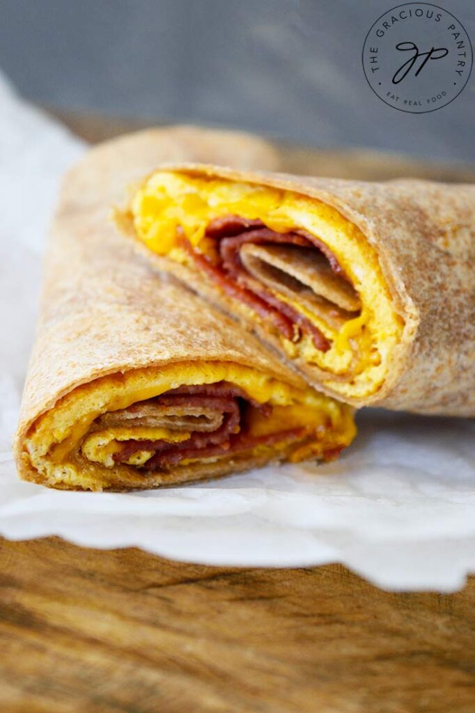 An up close view of a cut Bacon And Egg Wrap. You can see the egg, cheese and bacon.