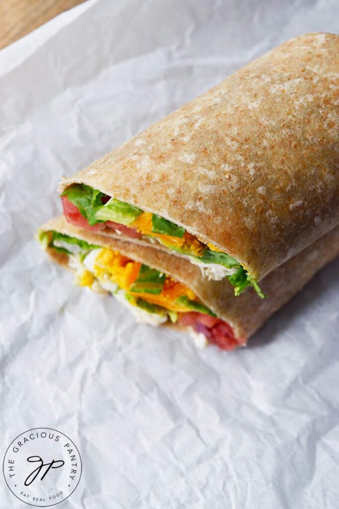 An overhead view looking down on a sliced Cobb Salad Wrap.