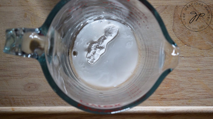 Starch and water in a measuring cup for making slurry.