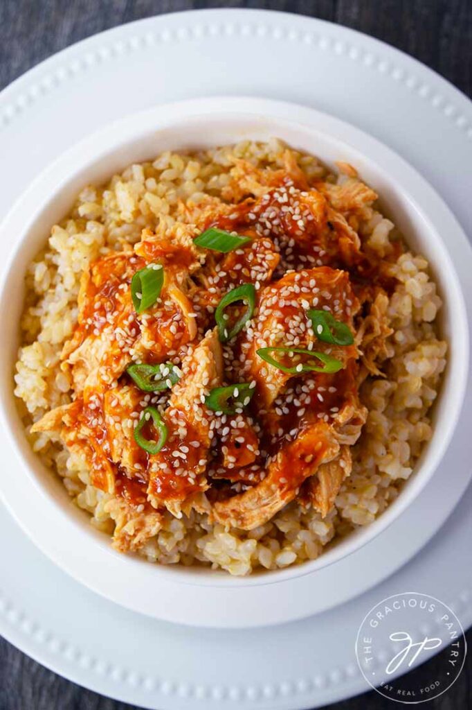 An overhead view looking down into a white bowl filled with Crock Pot Honey Sesame Chicken.