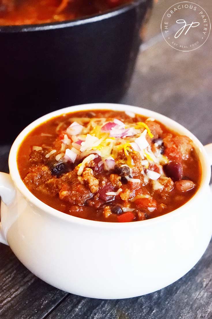 A white crock filled with Dutch Oven Chili.