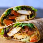 An up close shot of a fajita wrap cut and stacked on a cutting board.
