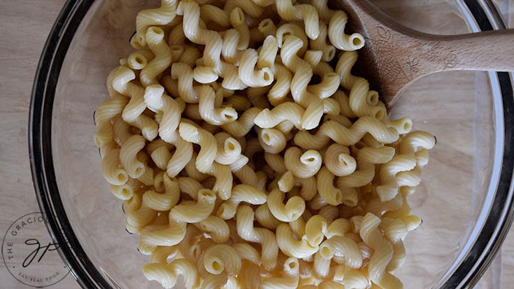 Cooked cavatappi pasta in a mixing bowl.