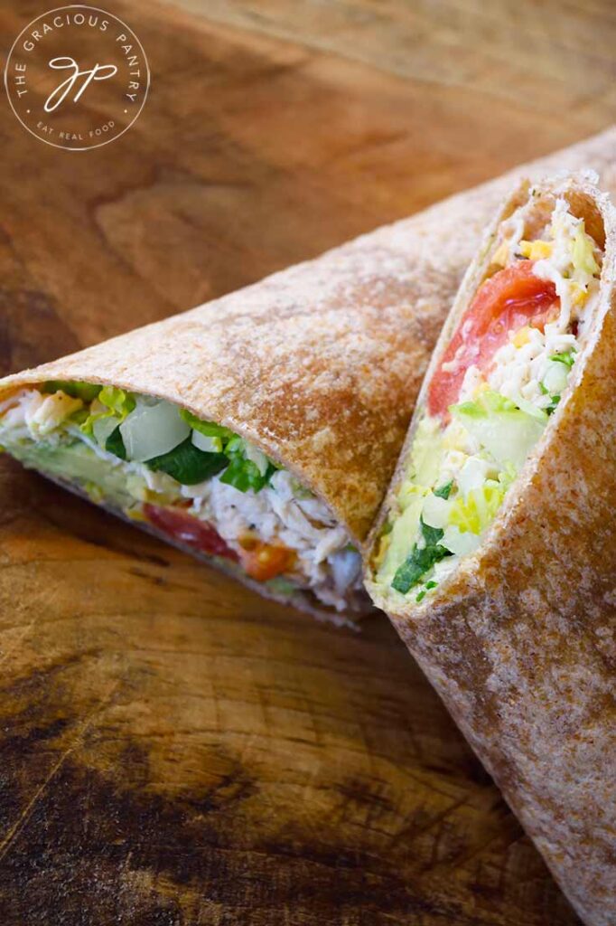 An overhead view looking down onto a cut and stacked Ranch Chicken Wrap on a cutting board.