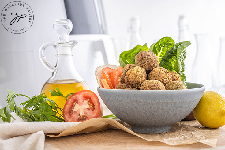 The finished falafel balls piled high in a gray bowl.