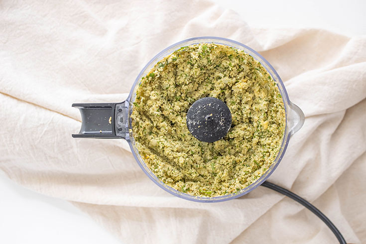 All the ingredients for this Air Fryer Falafel Recipe blended and sitting in a food processor on a white background.