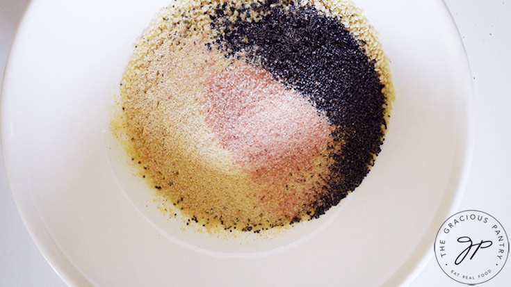 All the ingredients in this Everything Bagel Seasoning Recipe sitting in a small, white mixing bowl.