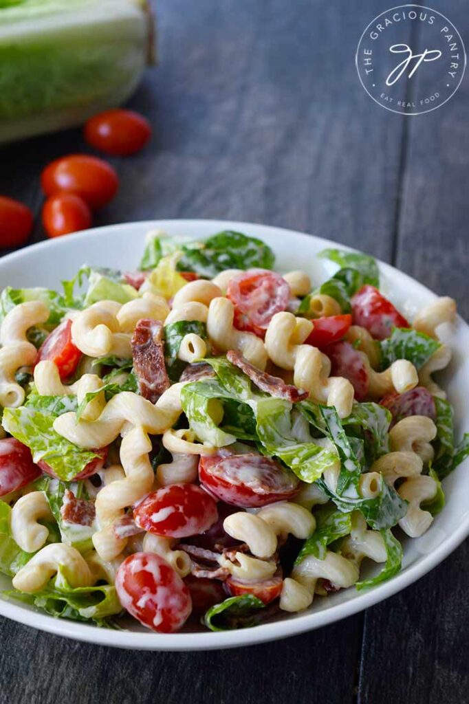 A front view of a white bowl filled with this BLT Pasta Salad.