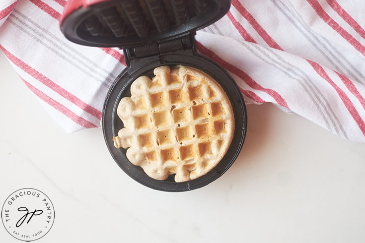 A just-made Buckwheat Waffle sitting in an open waffle maker.