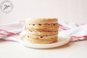 A stack of plain, just made Buckwheat Waffles sitting on a white plate.